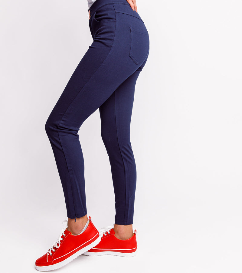 Side view of a woman wearing navy pants.