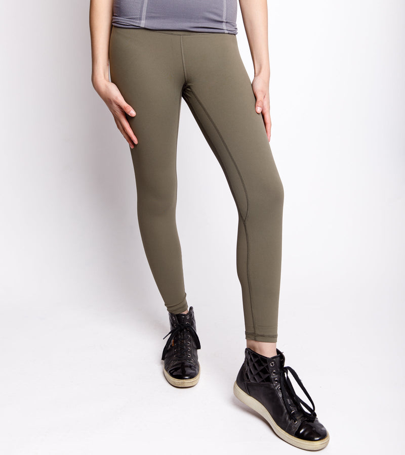 Front view of a woman wearing army green leggings.
