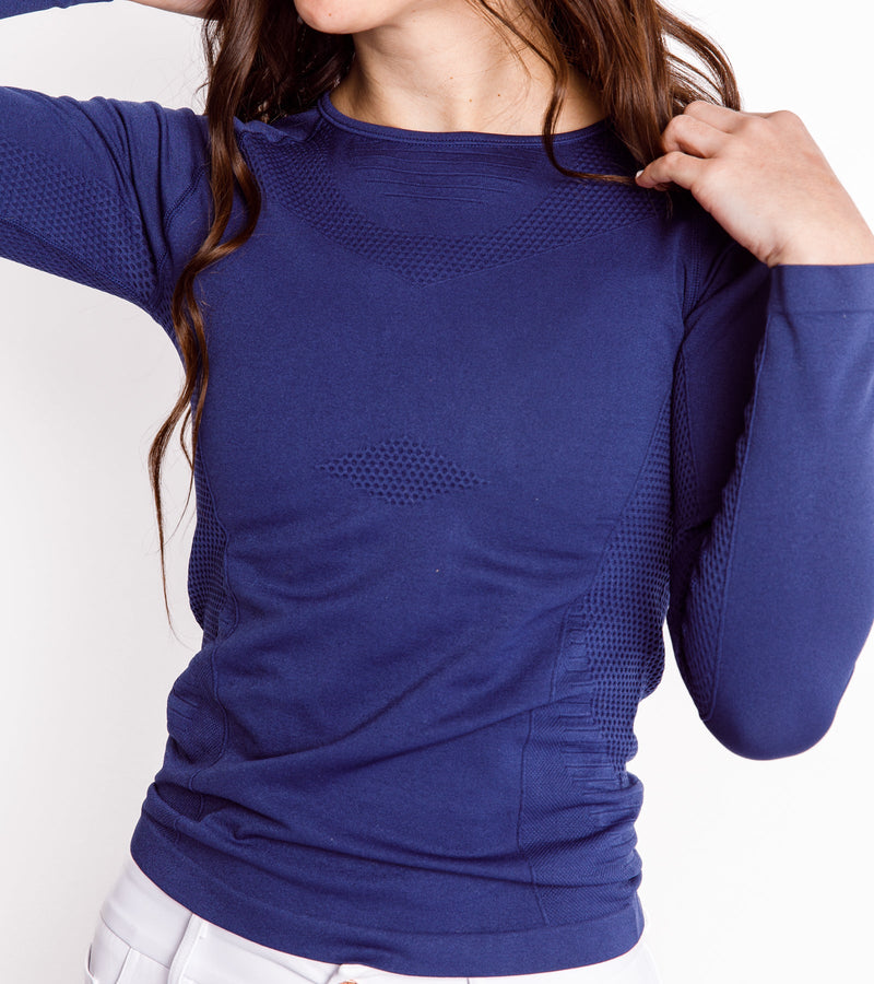 Front view of a woman wearing a long-sleeve navy shirt.