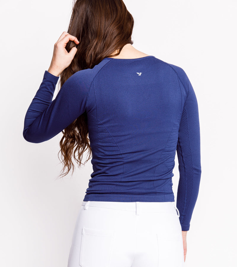 Back view of a woman wearing a long-sleeve navy shirt.