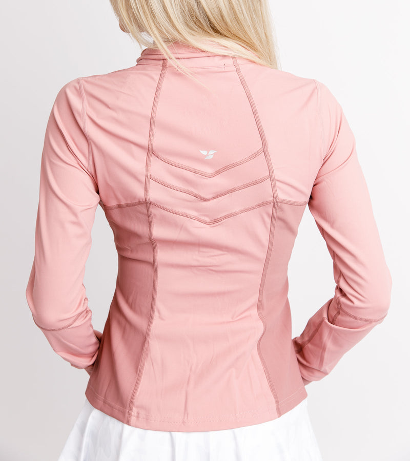 Close-up back view of a woman wearing a pink jacket with a chevron stitching.