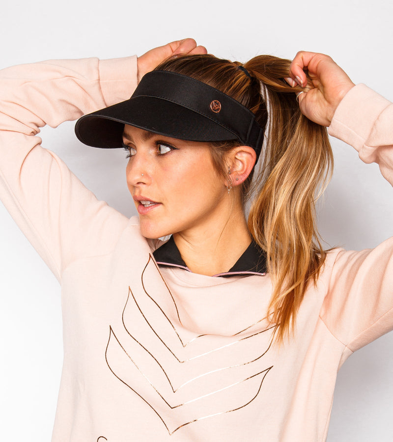 Woman wearing a black visor.