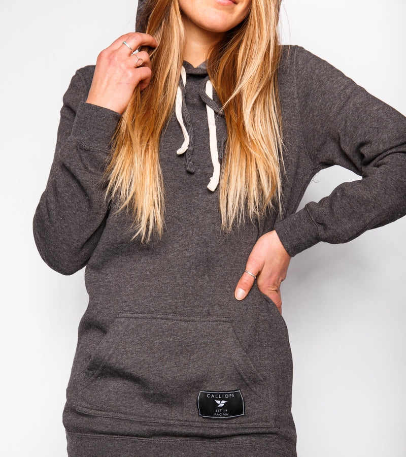 Close-up of a woman wearing a gray sweatshirt dress.