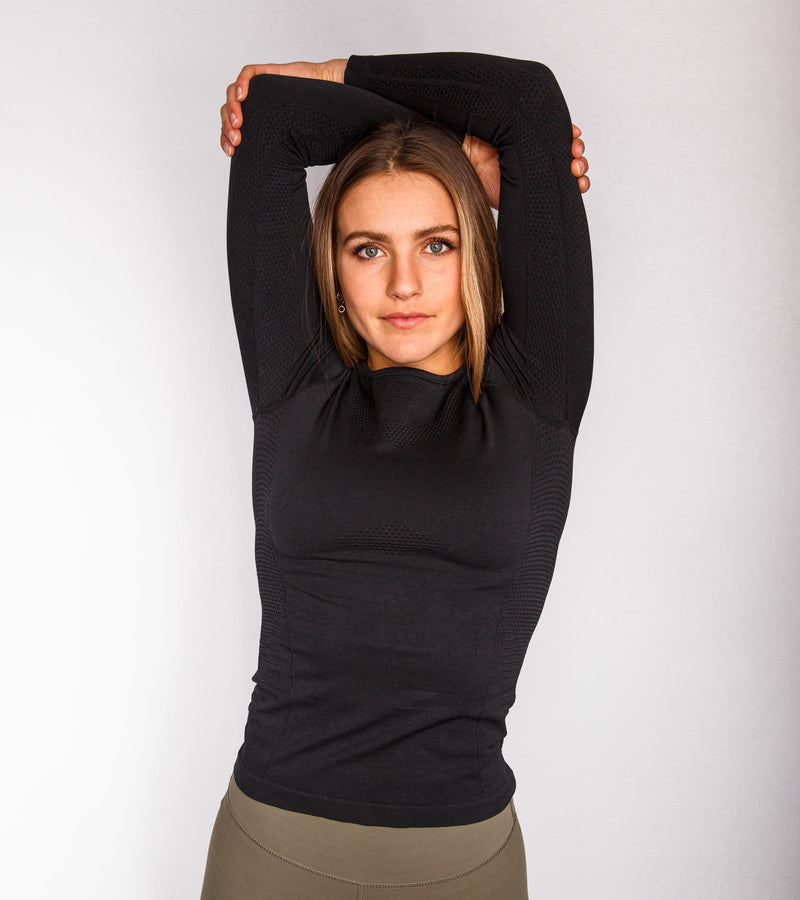 Front view of a woman wearing a long-sleeve black top.