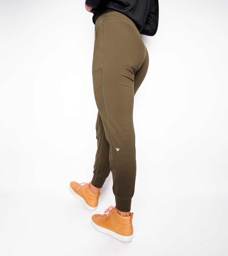 Back view of a woman wearing army green joggers.