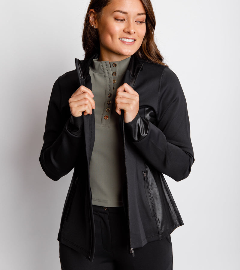 Close-up front view of a smiling woman wearing a black jacket with a full front zip and side-bonded zipper pockets.