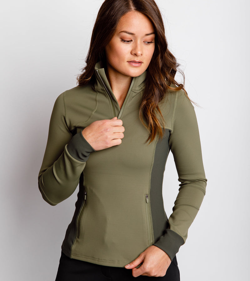 Close-up front view of a woman wearing an army green pullover with a neckline zipper and side-bonded zipper pockets.