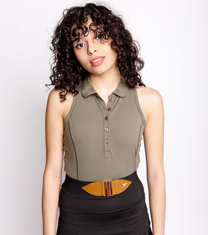 Close-up view of a woman wearing a sleeveless army green polo with a deep front button placket and Princess stitch side seams for a more fitted look, a black and honey belt, and black bottom.